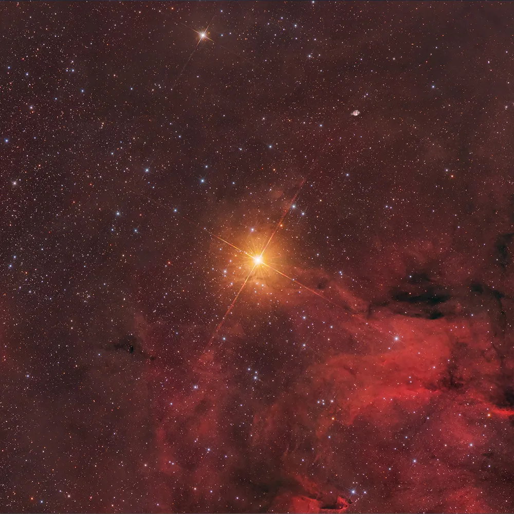 A estrela supergigante vermelha Mu Cephei rodeada de nebulosidade avermelhada
